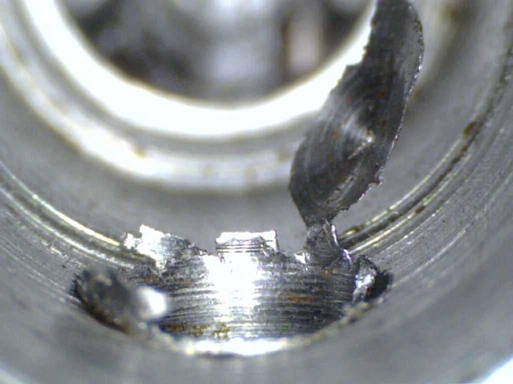 Closeup of a metal burr on a hole