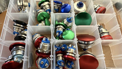 Storage box with a bunch of multi-colored metal mushroom
pushbuttons