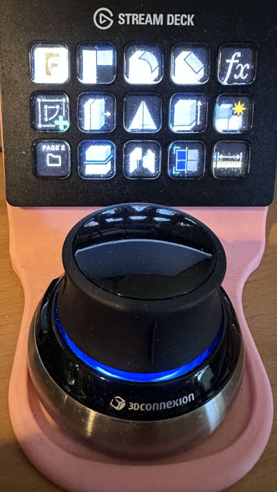 A 3Dconnexion Space Mouse with a El Gato Stream Deck behind
it